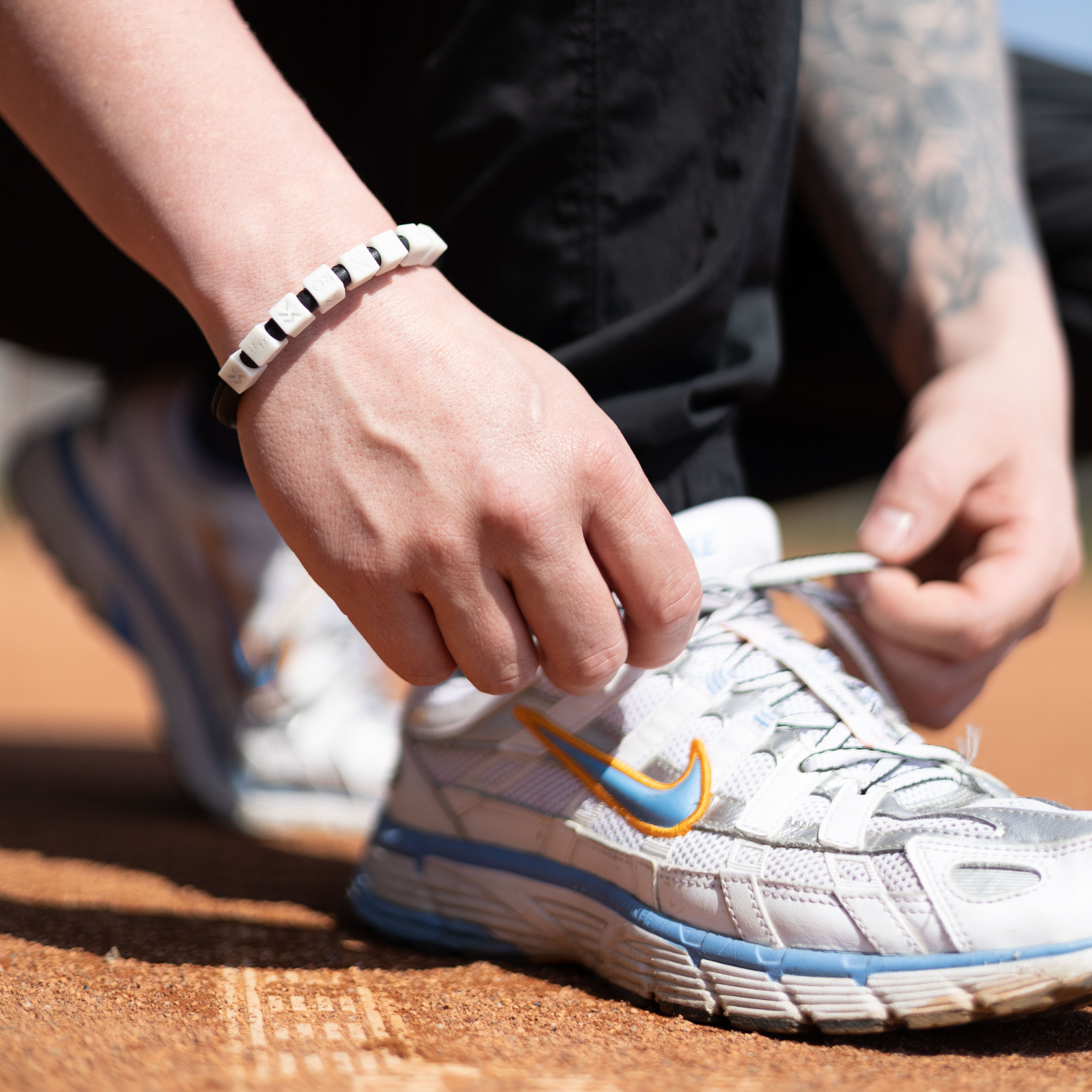 model on tennis court with bracelet